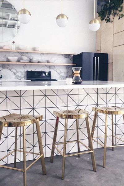 tiled kitchen counter island in modern kitchen with marble backsplash